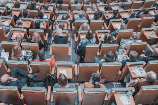 People sitting in chairs listening to lecture